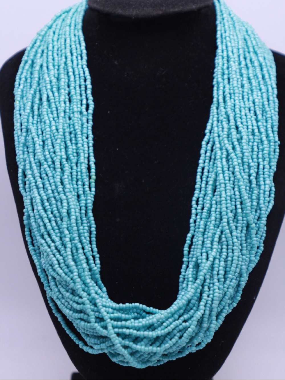 Turquoise Multi-Strand Seed Bead Necklace black knit button closure